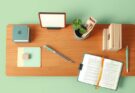 A minimalist workspace with plants, journals, and a tidy organisation reflecting productivity and well-being.