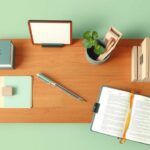 A minimalist workspace with plants, journals, and a tidy organisation reflecting productivity and well-being.